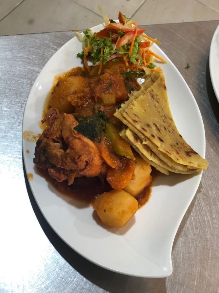 A plate featuring tender liver pieces alongside fluffy chapatis, a flavorful dish served at Irman Restaurant and Cafe.